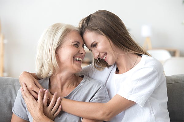 Happy-loving-older-mature-mother-and-grown-millennial-daughter-laughing-embracing